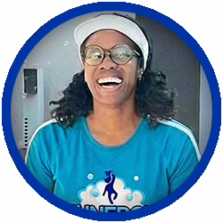 staffer A person wearing glasses, a white visor, and a blue shirt with a unicorn logo is smiling widely. The image is framed by a blue circular border.